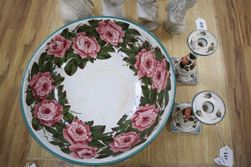 A Wemyss pottery Cabbage rose decorated toilet bowl, diameter 39cm, and a pair of Weymss style candlesticks by Griselda Hill pottery